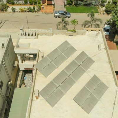Photo by contact me +923323219715 Aerial shot of solar panels on a rooftop in Karachi, highlighting sustainable energy solutions in urban settings.